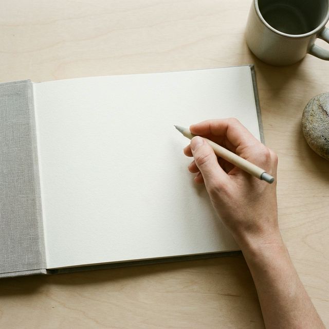 Hands writing in a notebook